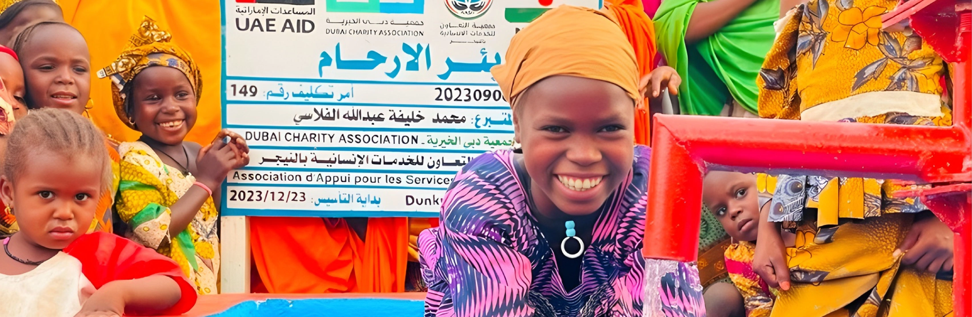 Girl with water from a well built by UAE Aid and Dubai Charity Association in Niger in 2023 