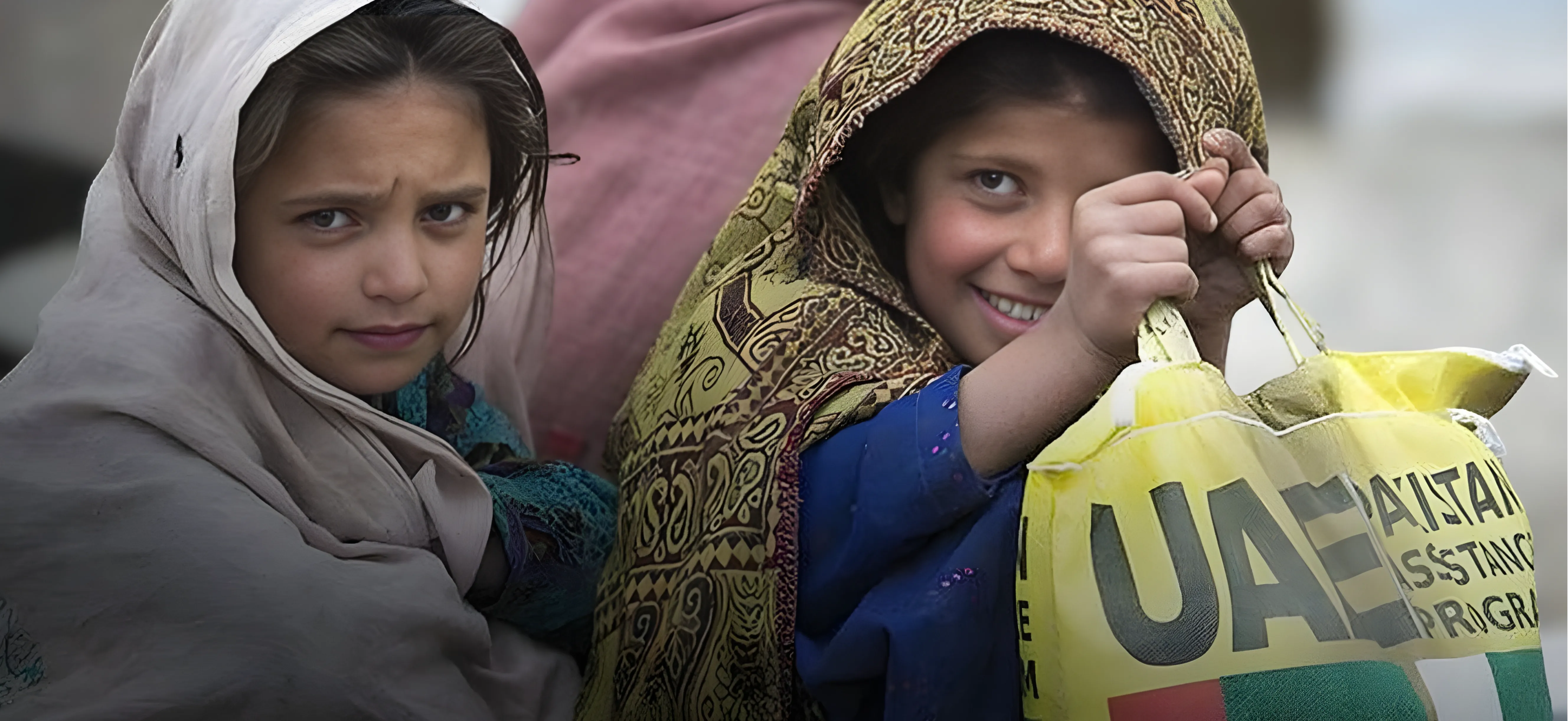 Two girls in Pakistan with UAE Aid assistance package